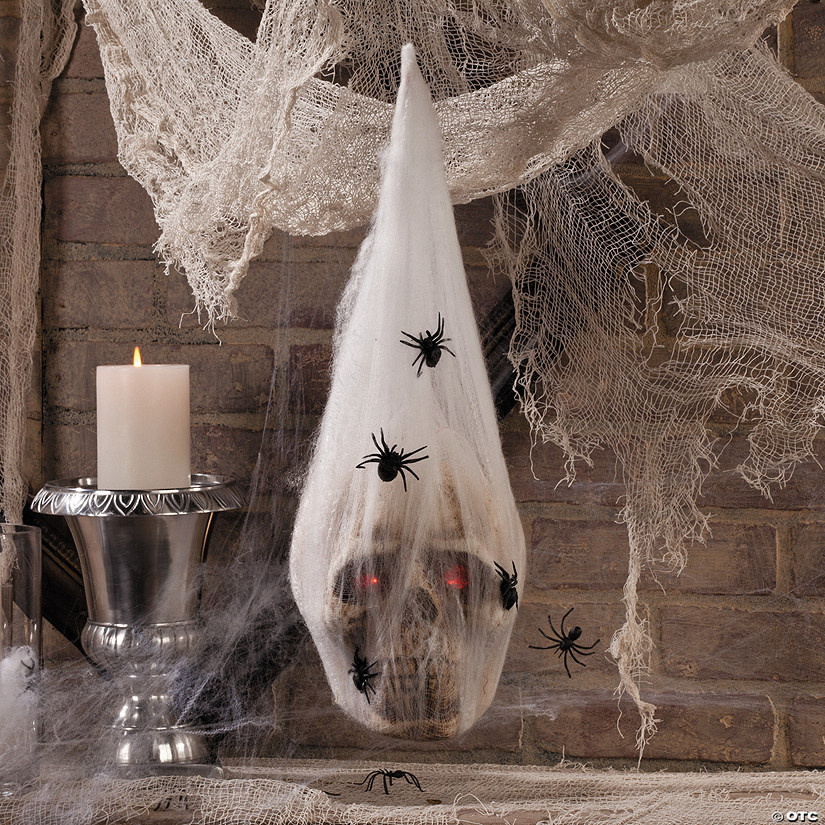 7 1/2" LED Light-Up Skull in Spider Cocoon Foam Halloween Decoration Image