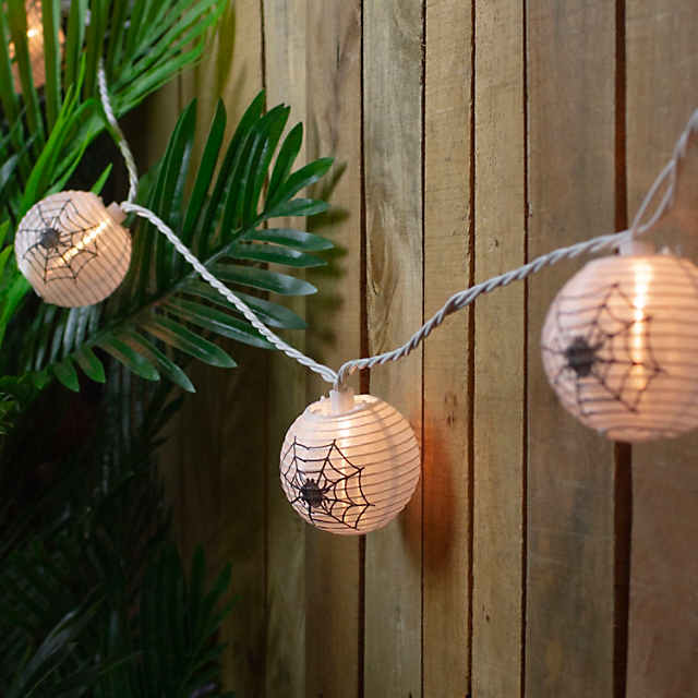 https://s7.orientaltrading.com/is/image/OrientalTrading/PDP_VIEWER_IMAGE_MOBILE$&$NOWA/10-count-black-spider-in-web-paper-lantern-halloween-lights-8-5ft-white-wire~14256855-a01