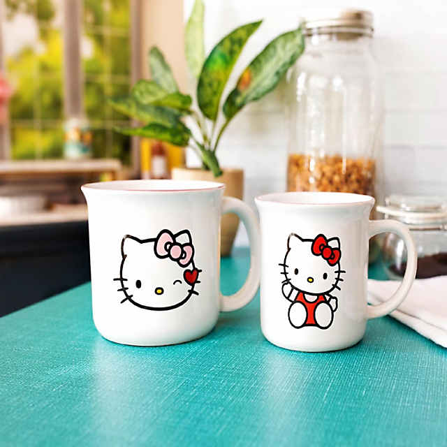 https://s7.orientaltrading.com/is/image/OrientalTrading/PDP_VIEWER_IMAGE_MOBILE$&$NOWA/hello-kitty-9-and-16-ounce-ceramic-camper-mug-set-of-2~14260214-a01$NOWA$