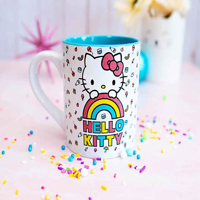 https://s7.orientaltrading.com/is/image/OrientalTrading/PDP_VIEWER_IMAGE_MOBILE$&$NOWA/sanrio-hello-kitty-rainbow-glitter-ceramic-mug-holds-14-ounces~14260130-a01$NOWA$