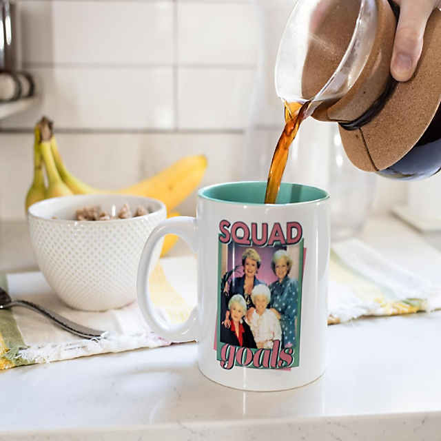 https://s7.orientaltrading.com/is/image/OrientalTrading/PDP_VIEWER_IMAGE_MOBILE$&$NOWA/the-golden-girls-squad-goals-ceramic-mug-holds-20-ounces~14352072-a01$NOWA$