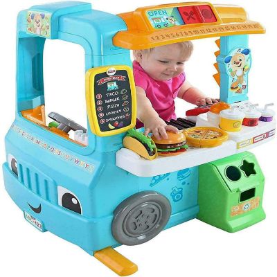 Fisher-Price Laugh & Learn Servin' Up Fun Food Truck with 20+ Piece Accessory Set Image 1