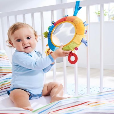 HABA Rainbow Discovery Mirror - Hang from Crib or Use as a Pillow with Entertaining Elements for Baby to Explore Image 1