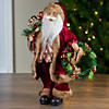 Northlight 18" Red Santa Claus Holding a Wreath and Gift Bag Christmas Figurine Image 1